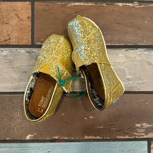 Gold Baby Glitter Toms.